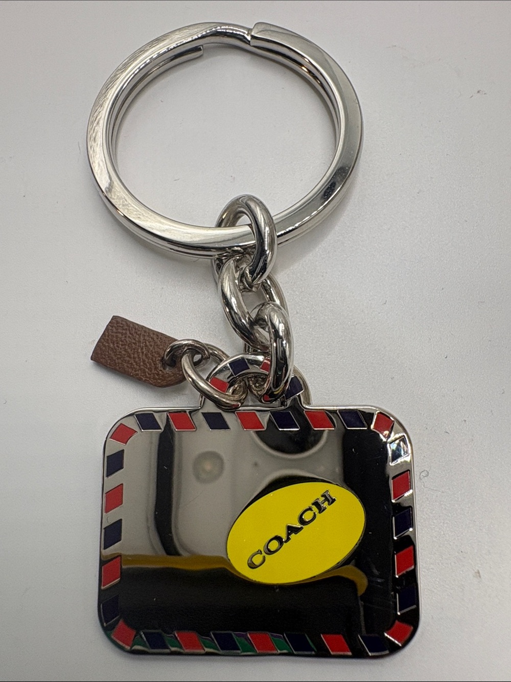 Coach Silver Keychain with Yellow Logo and Red & Blue Enamel Trim